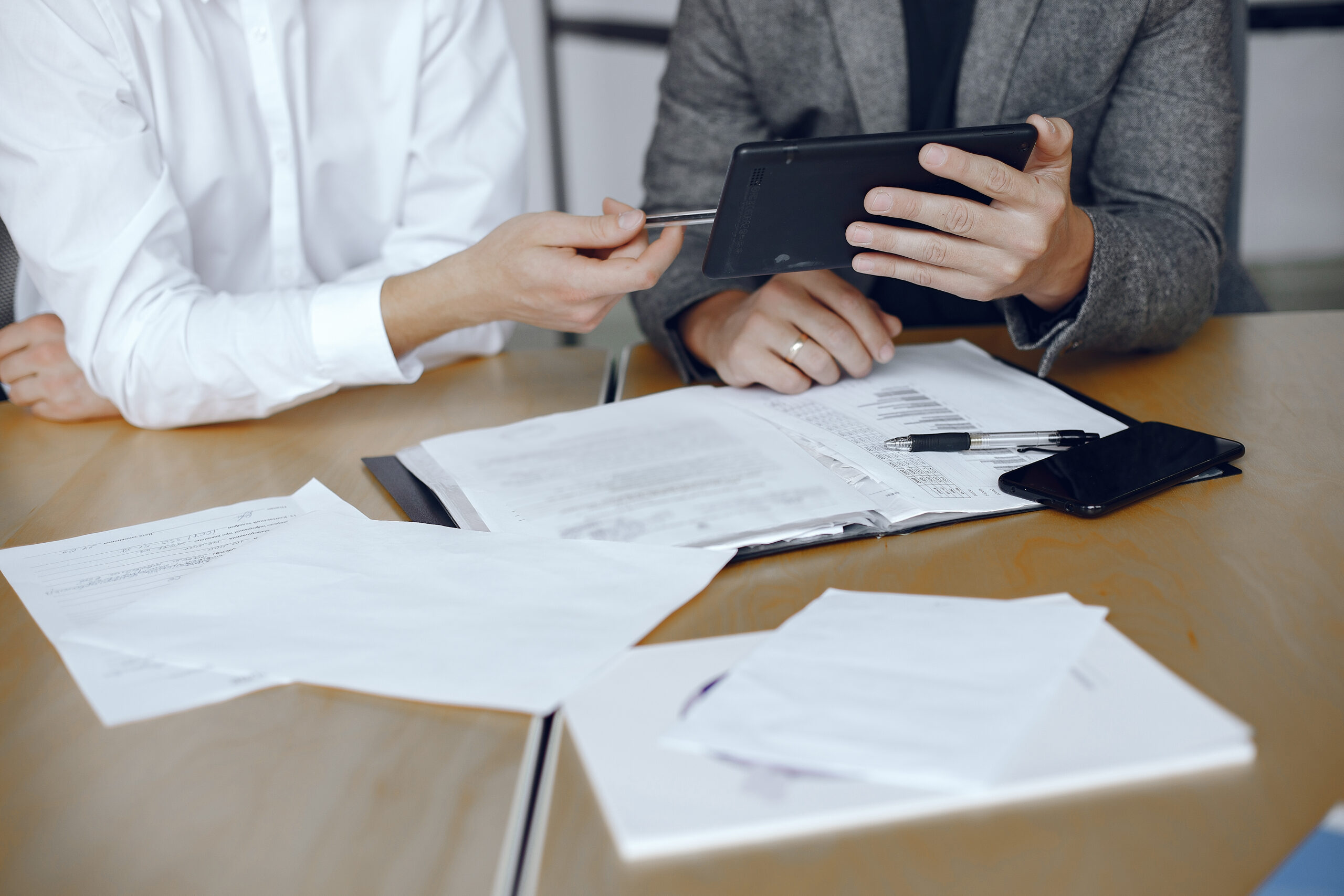Two business partners signing a document